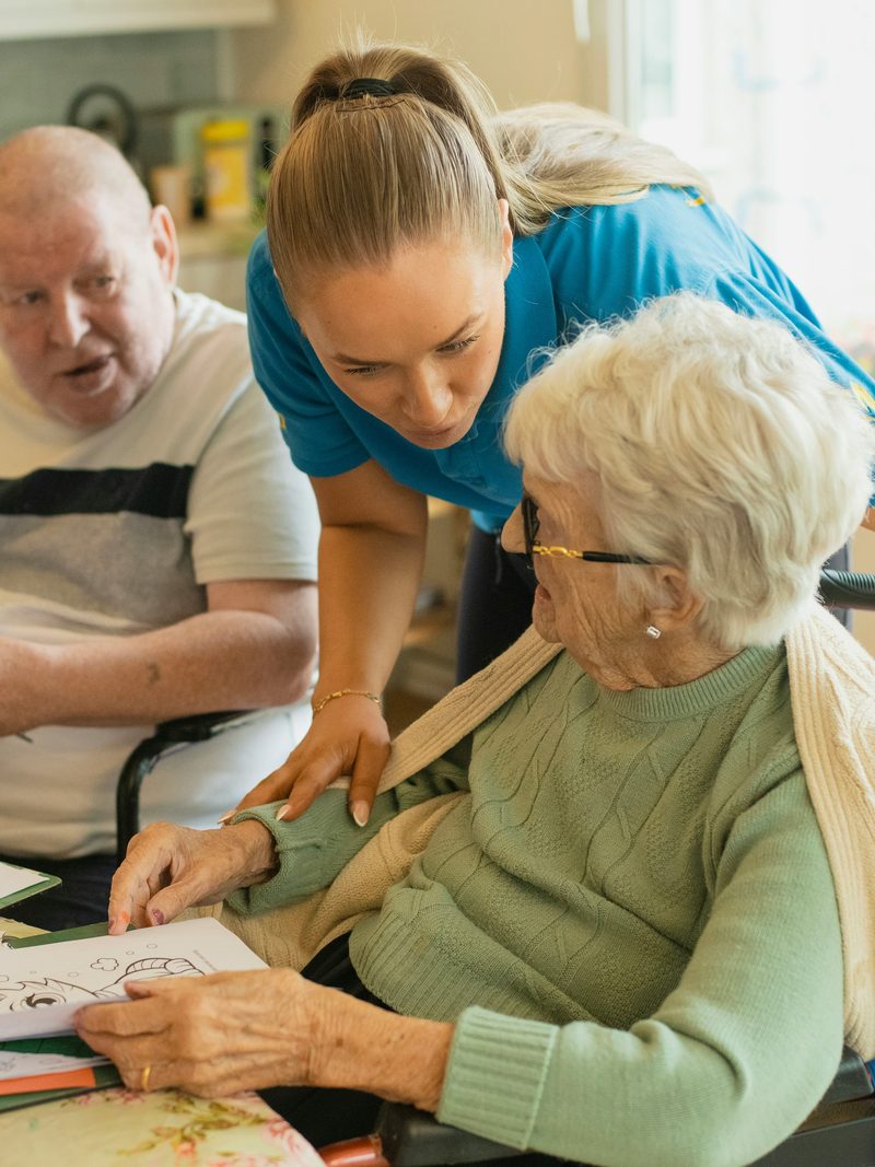 Nurse with a resident in a care home